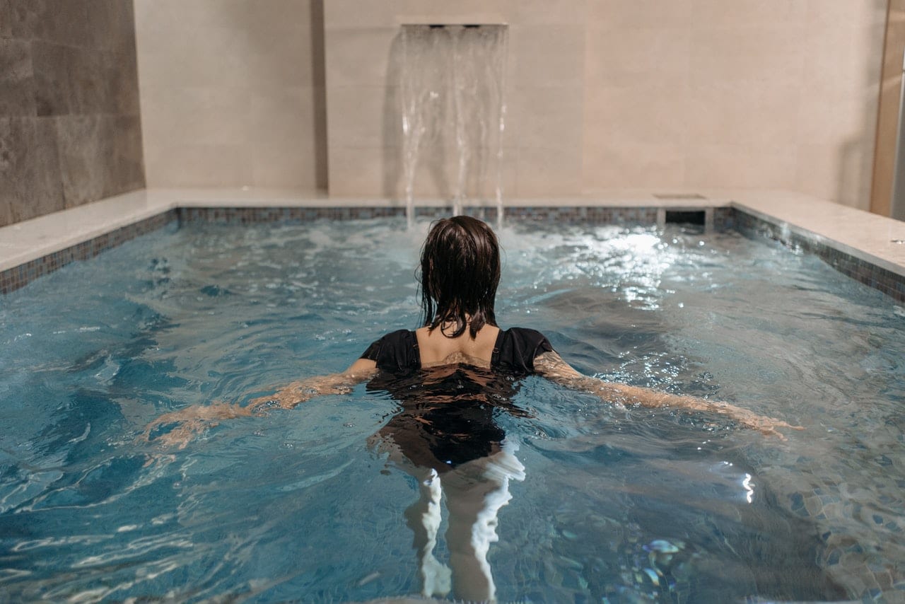Woman in Black Swimsuit in Swimming Pool